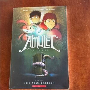 Scholastic Amulet Graphic Novel with Red and Green Cover